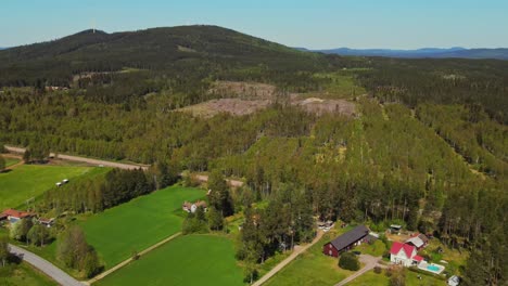 Countryside-Landscape-With-Green-Fields-And-Lush-Mountain-In-Hunflen,-Appelbo,-Dalarna,-Sweden---aerial-shot