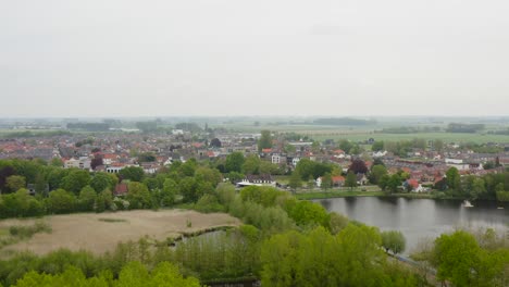 Aerial-approach-to-the-city-of-Axel-in-the-Netherlands-shot-on-a-wet-cloudy-day