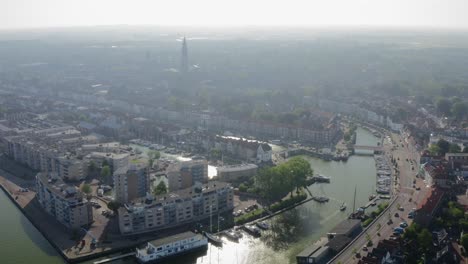 Aerial-shot-of-a-waterway-in-the-historical-town-of-Middelburg,-the-Netherlands,-on-a-sunny-summer-evening