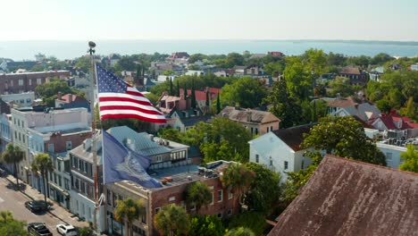 USA-flag-in-Charleston,-aerial-pullback-reveals-St