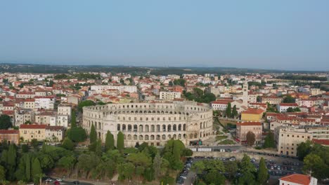 Aerial-arc-shot-circling-around-Pula-Arena-in-Pula,-Croatia-in-the-afternoon