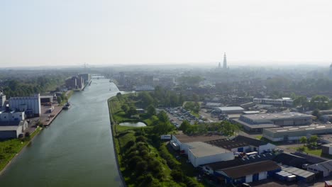 Aerial-shot-of-the-Canal-through-Walcheren-and-the-historical-town-of-Middelburg,-the-Netherlands,-on-a-sunny-summer-evening
