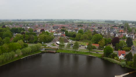 Aerial-approach-to-the-shore-of-De-Kleine-Kreek-small-pond-in-the-city-of-Axel-in-the-Netherlands
