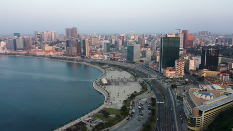 Traveling-front,-Luanda-city,-golden-hour-flying-over-Luanda-bay,-Africa-#3