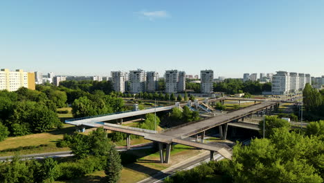 Foot-bridge-in-center-of-Zaspa-district-in-Gdansk-crossing-road,-aerial
