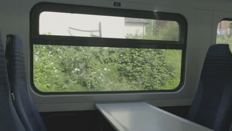 Interior-view-at-train's-empty-window-seat-window-move-through-countryside-in-the-north-of-the-UK