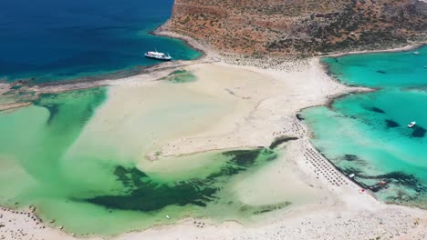 Aerial-flying-over-Balos-Beach-and-Lagoon-with-turquoise-water,-mountains-and-cliffs-in-Crete,-Greece
