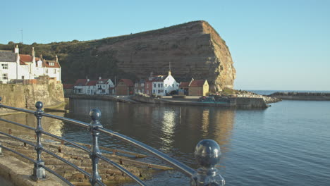 North-York-Moors,-Staithes-Clip-7,-Pan-of-Harbour-towards-Cowbar,-North-Yorkshire-Heritage-Coast,-Video,-,-4096x2160-25fps,-Prores-422
