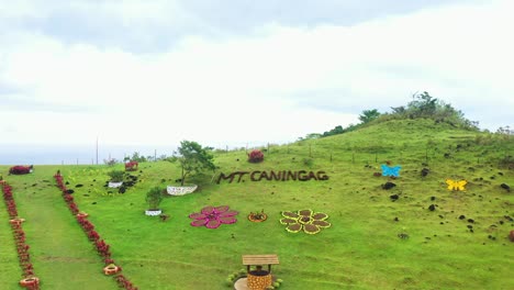 Beautiful-Decorations-On-Lush-Green-Mountain-At-Caningag-Mountain-Park-In-Pintuyan,-Southern-Leyte,-Philippines---drone-ascending