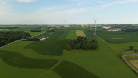 Vista-Aérea-Del-Paisaje-Americano-Rural---Las-Turbinas-Eólicas-Producen-Energía-Renovable-En-Segundo-Plano