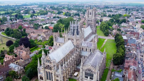 Aerial:-Ely-Cathedral-with-urban-city-residential-area-in-England,-drone-tracking-shot