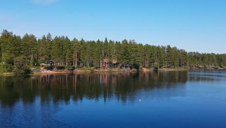 Calm-Lake-With-Reflections---Lake-Busjon,-Appelbo,-Dalarna,-Sweden---aerial-drone-shot