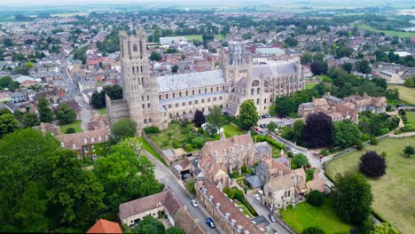 Aerial-view-of-Ely-Cathedral-with-urban-cityscape-in-England,-drone-rotation-shot