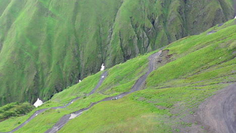 Drone-shot-of-vehicle-driving-on-the-Road-to-Tusheti,-one-of-the-worlds-most-dangerous-roads