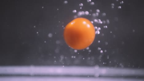 Slow-motion-shot-of-bouncing-cherry-tomatoes-in-water
