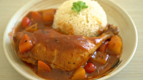 homemade-chicken-stew-with-tomatoes,-onions,-carrot-and-potatoes-on-plate-with-rice