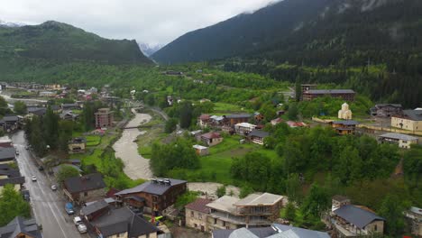 Aerial:-river-flowing-through-Mestia-in-Zemo-Svaneti,-Georgia-Caucasus-Mountains