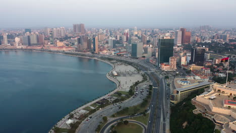 Fast-motion-traveling-front,-Luanda-city,-golden-hour-flying-over-Luanda-bay,-Africa-