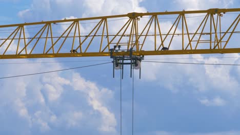 Big-yellow-crane-moving-a-load-along-its-jib