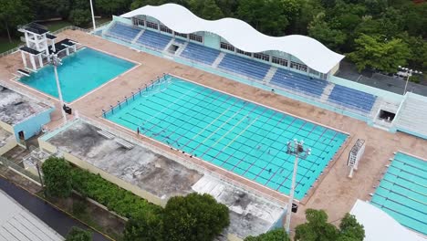 drone-shot-in-swimming-sport-area,-olympic-swimming-pool-in-the-olympic-pavilion-of-santo-domingo-dominican-republic