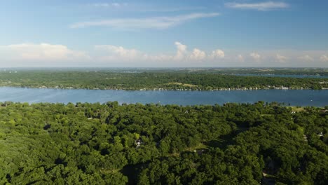 Aerial-Sliding-Shot-Along-Big-Blue-Lake,-Reveals-Suburban-Homes-and-Golf-Course