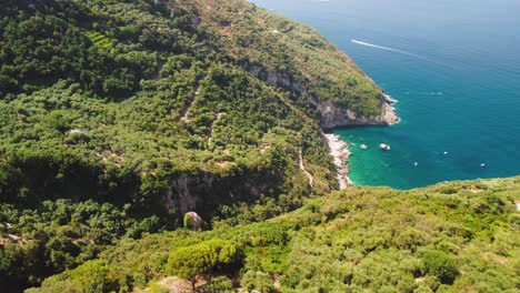 Aerial---Lush-Punta-Campanella-coastline-showing-idyllic-beach,-Tyrrhenian-Sea,-Italy