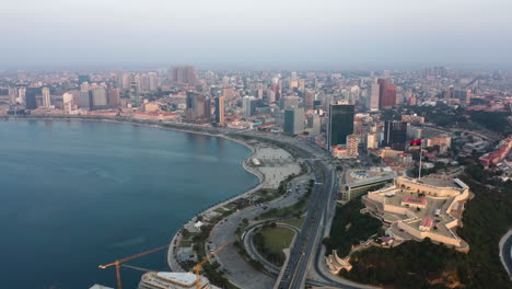 Traveling-front,-Luanda-city,-golden-hour-flying-over-Luanda-bay,-Africa-#1