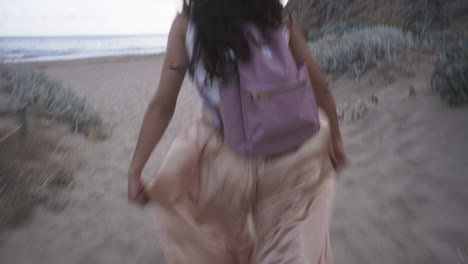 Bubbly-childlike-latino-woman-exploring-beach-Barcelona