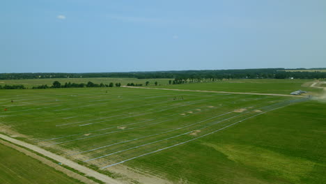 Site-of-the-largest-photovoltaic-farm-in-Central-Europe,-Aerial-orbit-over-renewable-solar-panels-field-during-construction,-Zwartowo,-Poland