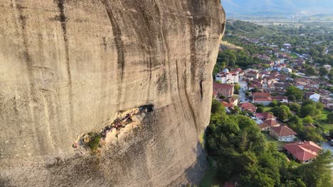 Approaching-a-wide-decorated-cave-in-Meteora,-Greece-with-a-drone,-aerial