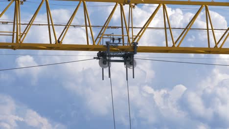 Yellow-construction-crane-working-high-in-the-sky