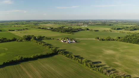 Amazing-Aerial-Establishing-Shot-Approaching-Rural-Farm-on-Beautiful-Summer-Day