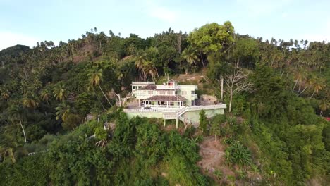 Panoramic-drone-aerial-view-of-a-family-villa-in-the-mountains-near-the-bay-of-samana,-dominican-republic