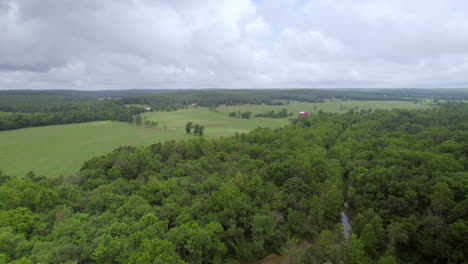 Aerial-pull-back-away-from-beautiful-country-landscape-an-dover-forest-with-stream