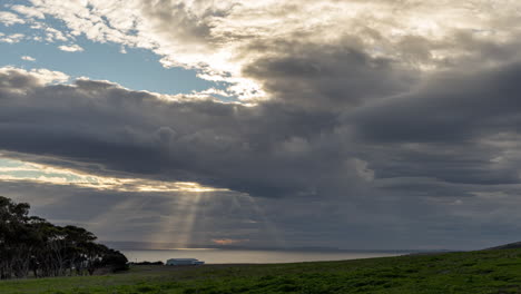 Sunrays-burst-from-a-cloudy-sky-and-illuminate-the-ocean-in-time-lapse-from-Kangaroo-Island