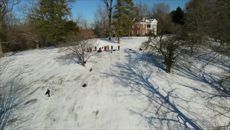 A-group-of-people-snow-sledding-on-the-side-of-a-hill---aerial-view