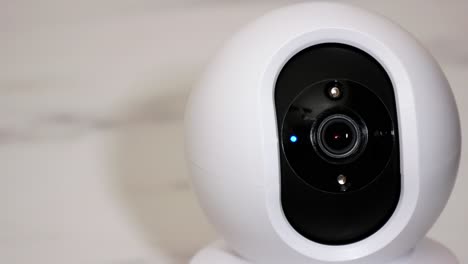 Smartphone-controlled-home-security-camera-moving-filming-around