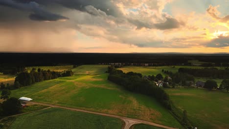 Panoramic-View-Of-Rural-Landscape-With-Green-Fields-And-Cloudy-Sky-Near-Hjo,-Sweden---aerial-shot