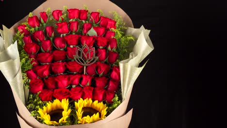 Roses-bouquet-and-sunflowers-arrangement-slider-shot-black-background