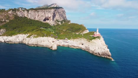 Aerial---Drone-panning-shot-around-Punta-Carena-lighthouse,-Capri,-Italy