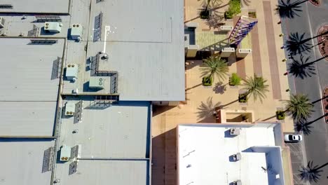 Aerial-view-looking-down-onto-commercial-building-roof,-inspecting-HVAC-units