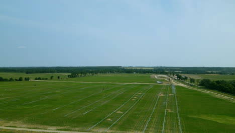 Aerial-large-green-field-for-installation-of-photovoltaic-panels,-largest-photovoltaic-farm-in-central-europe,-renewable-energy