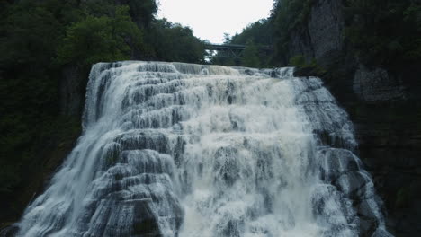 Ithaca-Falls-has-a-150ft-drop-and-width-of-175ft,-The-falls-are-in-an-amphitheater-formed-by-freezing-and-thawing-of-shale,-which-makes-up-the-gorge-walls