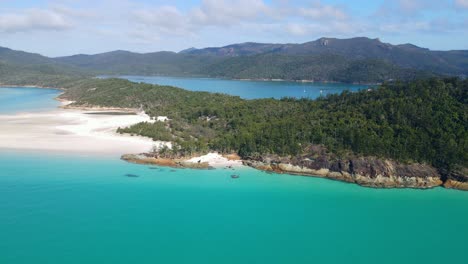 Turquoise-Blue-Waters-And-Swirling-White-Sand-With-Forested-Lookout