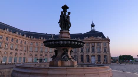 Fountain-of-the-three-graces-at-Place-de-la-bourse-in-Bordeaux-during-sunrise-with-nobody