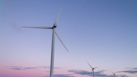 Close-up-of-wind-turbines-rotating-in-time-lapse-during-a-coloured-dusk-at-Hornsdale-Wind-Farm