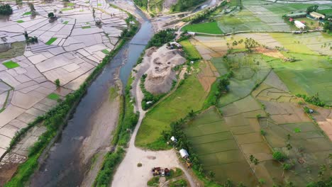 View-Of-An-Open-Pit-On-Working-Quarry-Area-Among-Paddy-Fields-And-River-in-Southern-Leyte,-Philippines