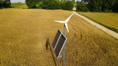 Autonomous-Lighting-Pole-with-Wind-Generator-and-Solar-Panel-Near-Yellow-Wheat-Field-in-Countryside-Czeczewo,-Poland,-Aerial-slide