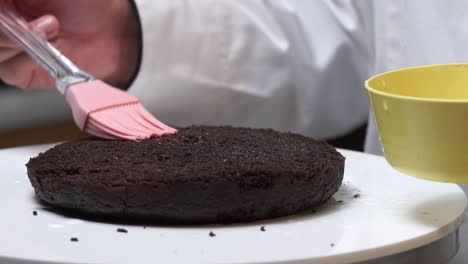spreading-rose-water-on-cake-making-prosess-close-up