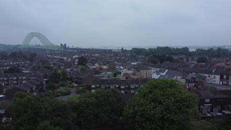British-Northern-Runcorn-bridge-suburban-residential-townhouse-neighbourhood-aerial-view-fast-left-dolly